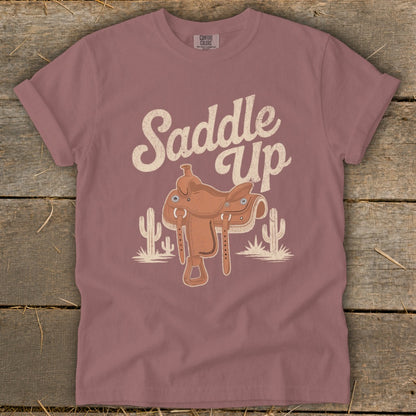 T-shirt with "Saddle Up" text, a cowboy saddle, and cacti illustration.