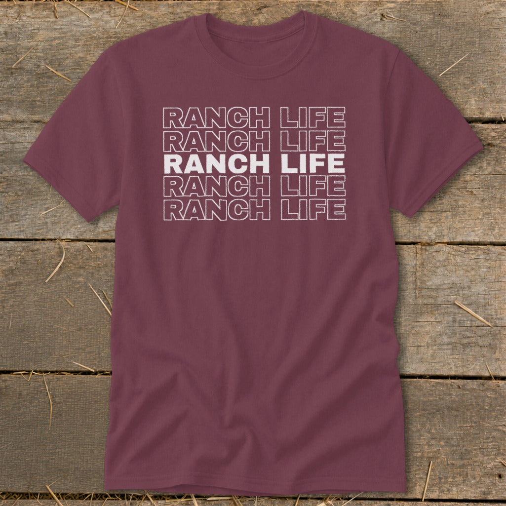 Maroon crewneck t-shirt featuring stacked white outline text reading Ranch Life on a rustic wood background.
