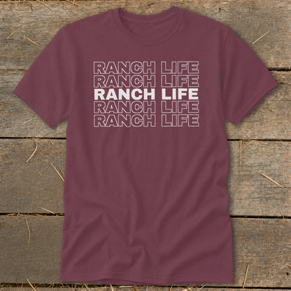 Maroon crewneck t-shirt featuring stacked white outline text reading Ranch Life on a rustic wood background.