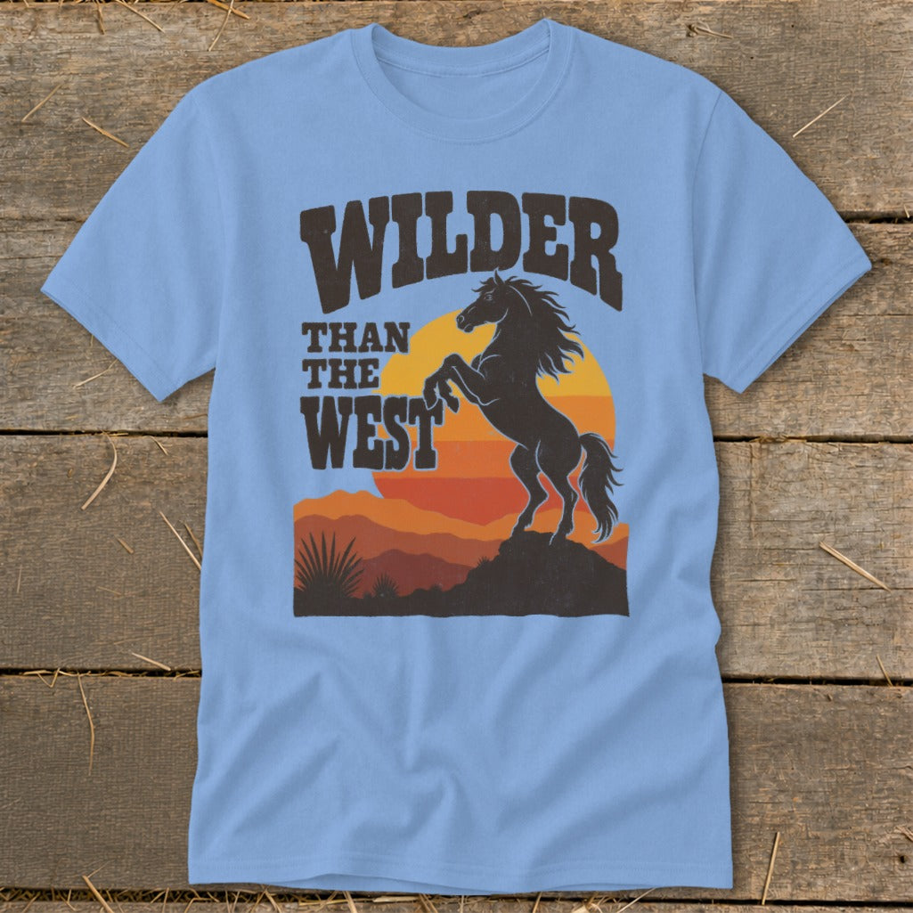 Light blue t-shirt with a dark graphic of a rearing horse and "Wilder Than The West" text.