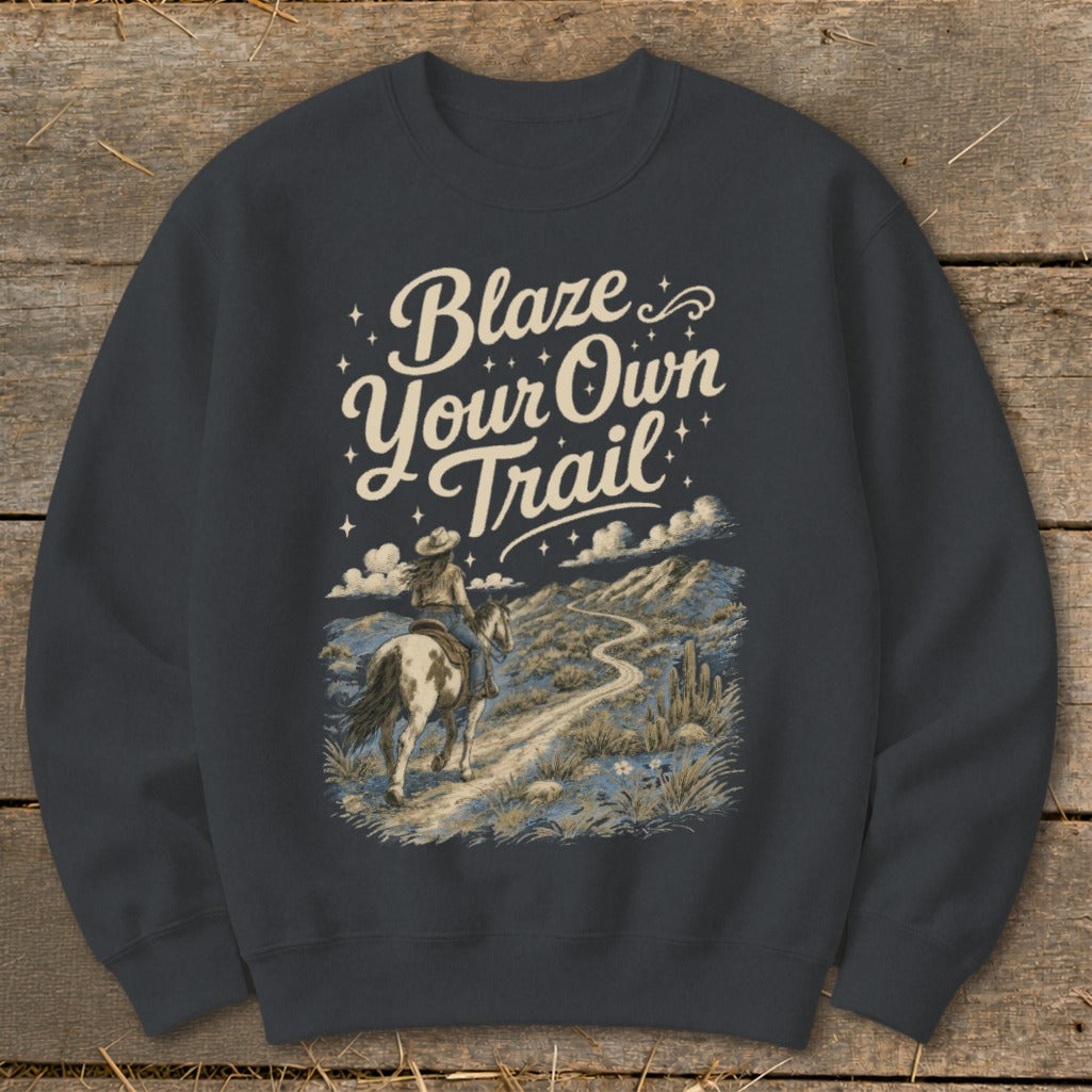 Crewneck sweatshirt with "Blaze Your Own Trail" text and desert landscape with a rider on horseback.