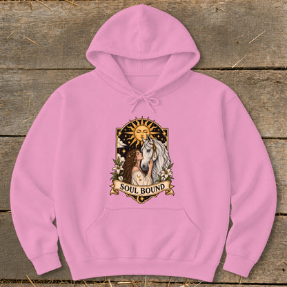 Pink hoodie with a "Soul Bound" graphic of a woman and horse under a sun.