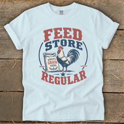 White t-shirt with "Feed Store Regular" text and a rooster by a bag of grain.