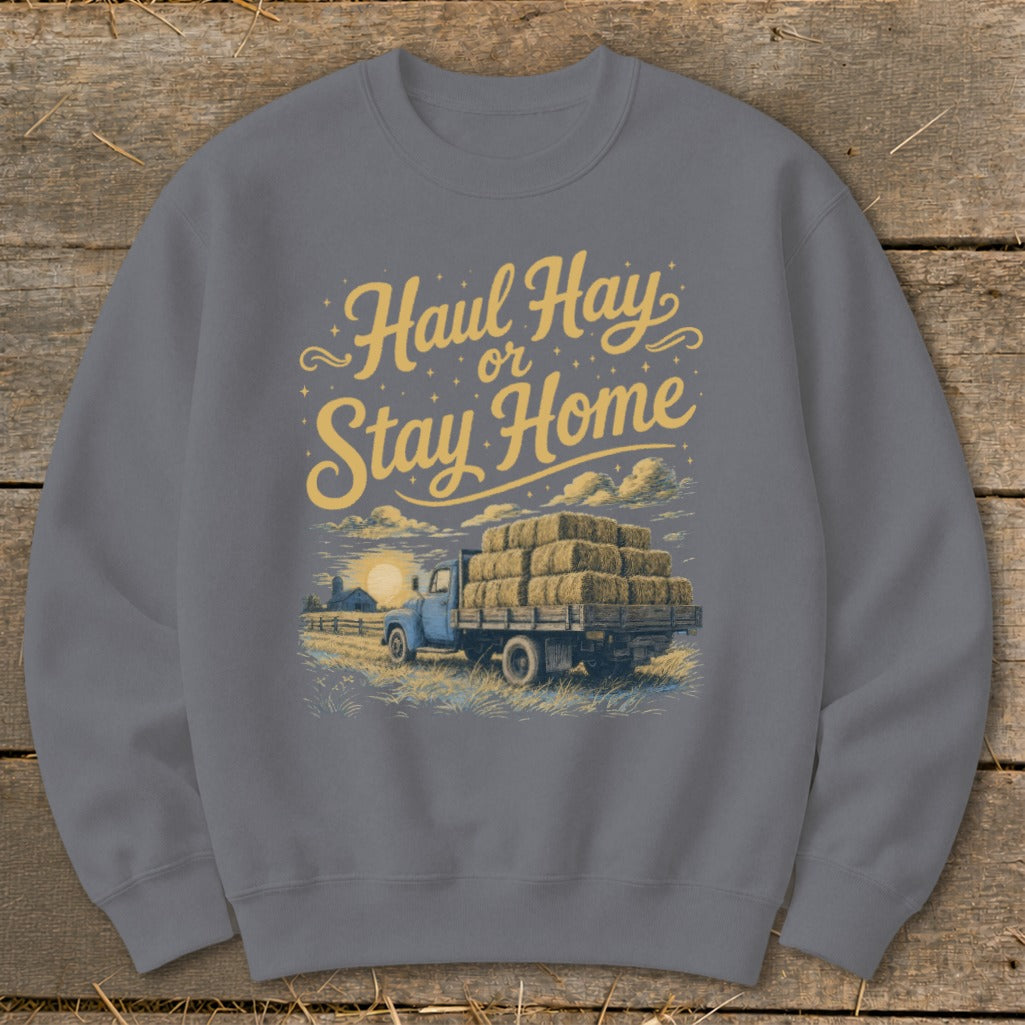 Sweatshirt with yellow text "Haul Hay or Stay Home" and illustration of a truck carrying hay bales.