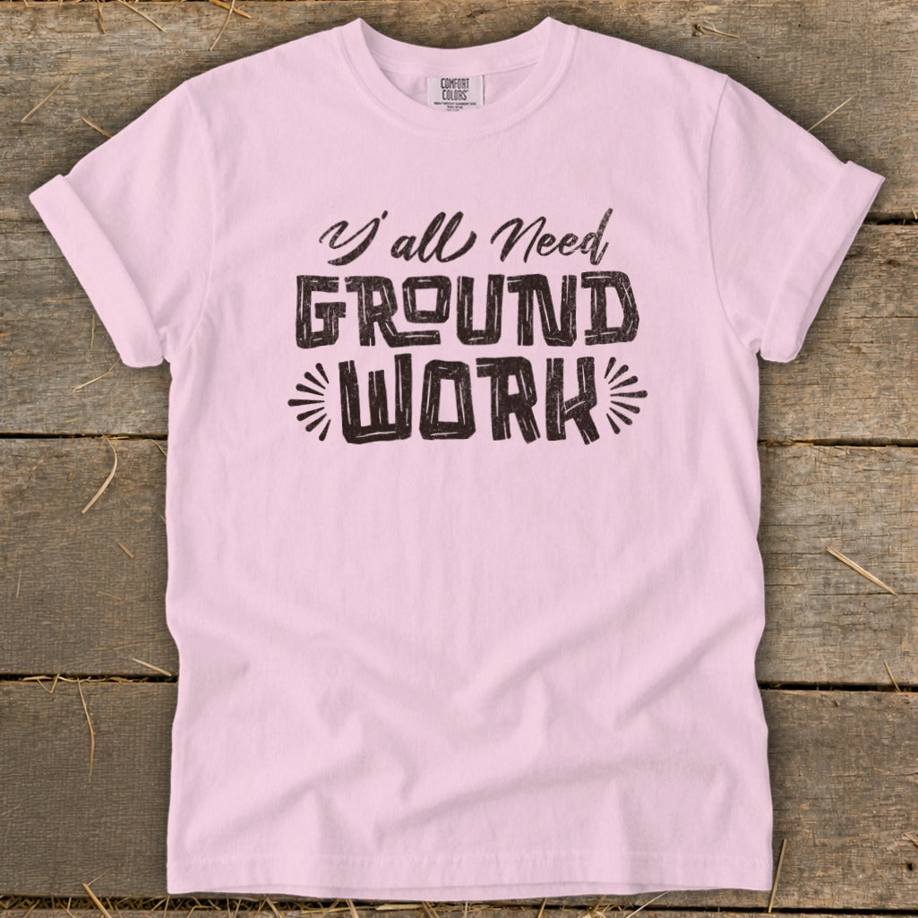 Light pink t-shirt with black text reading "Y'all Need GROUND WORK".