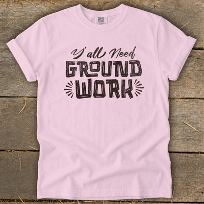 Light pink t-shirt with black text reading "Y'all Need GROUND WORK".