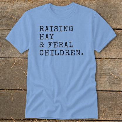Light blue t-shirt with black text "Raising Hay & Feral Children."