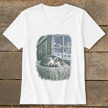 T-shirt with a sleeping cat on hay, looking out a window at a snowy barn scene.