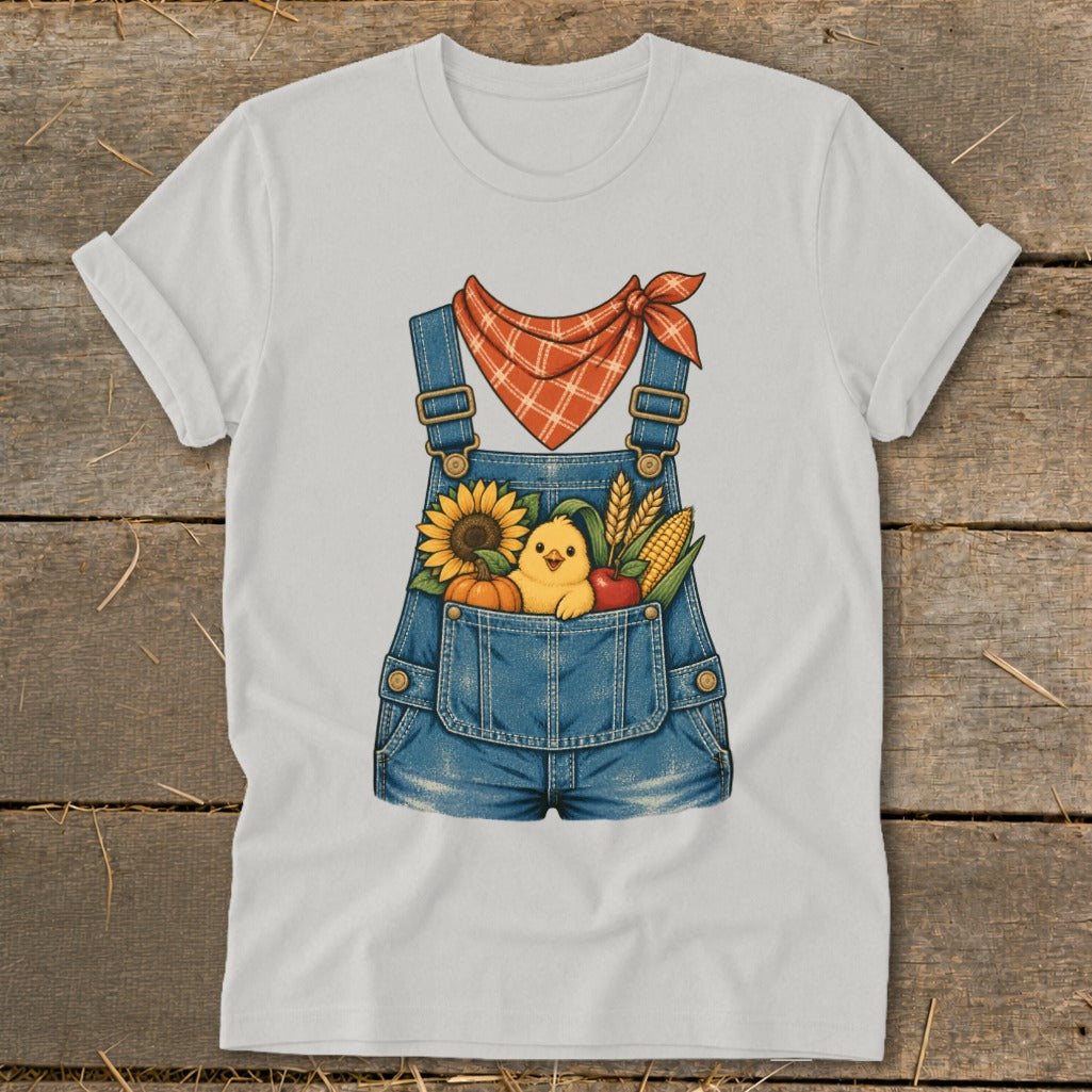 White t-shirt with denim overalls graphic, featuring a chick and farm produce.
