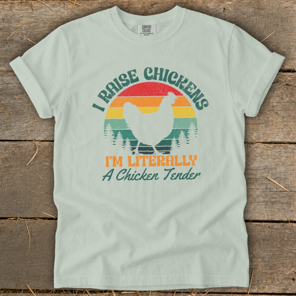 Light blue t-shirt with white chicken graphic and text "I RAISE CHICKENS I'M LITERALLY A Chicken Tender."