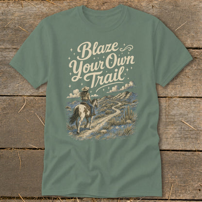 T-shirt with text "Blaze Your Own Trail" and desert landscape with person riding a horse.