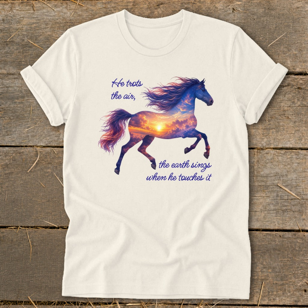 A cream-colored t-shirt featuring a galloping horse graphic filled with a sunset sky and inspirational text.