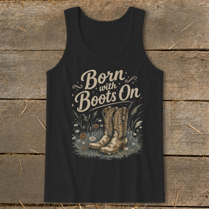 Black tank top with "Born with Boots On" text and cowboy boots in grass.