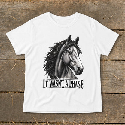White t-shirt with a detailed charcoal drawing of a horse's head and the text "IT WASN'T A PHASE".