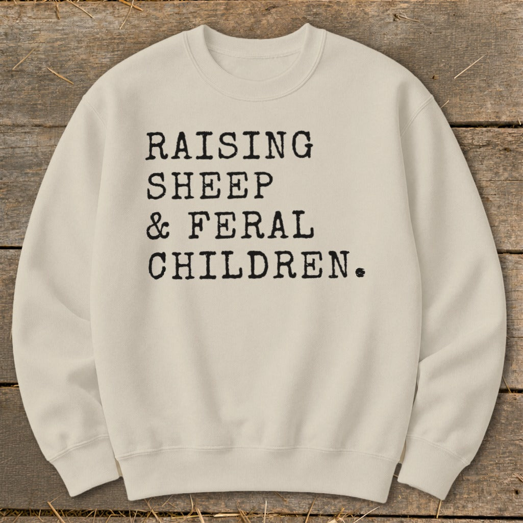 Cream sweatshirt with black text "RAISING SHEEP & FERAL CHILDREN."