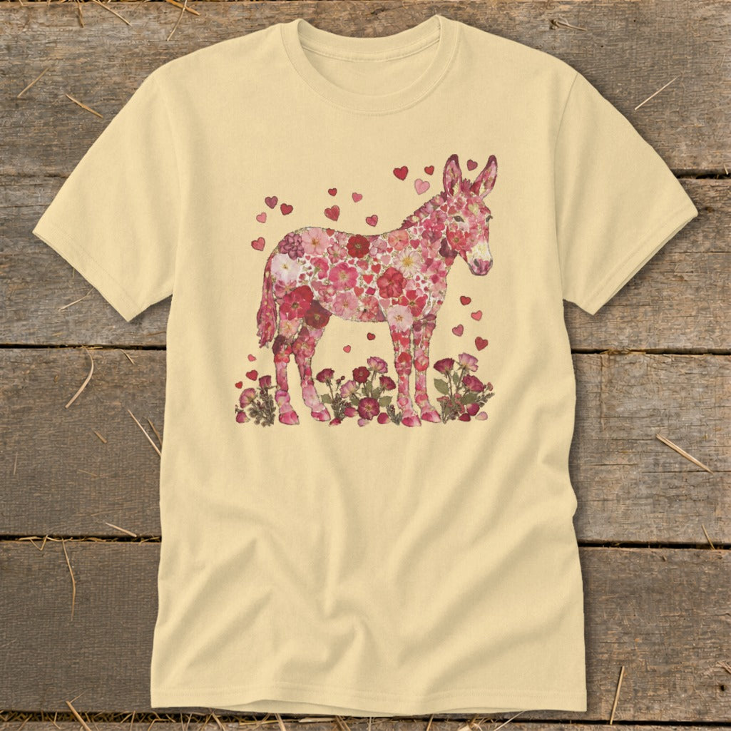 Donkey silhouette filled with pink flowers and hearts, standing among flowers.