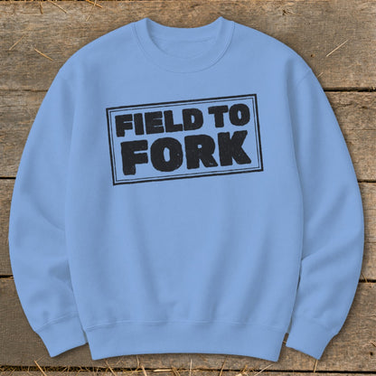 Light blue crewneck sweatshirt featuring a black boxed design with the text FIELD TO FORK.