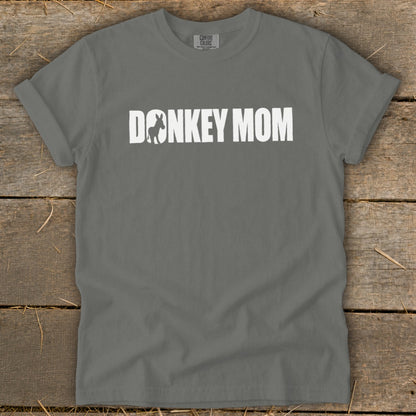 A grey crewneck t-shirt with rolled sleeves features white text reading DONKEY MOM, with a donkey silhouette inside the letter O.