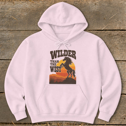 Pink hoodie with "WILDER THAN THE WEST" text and a rearing horse graphic.