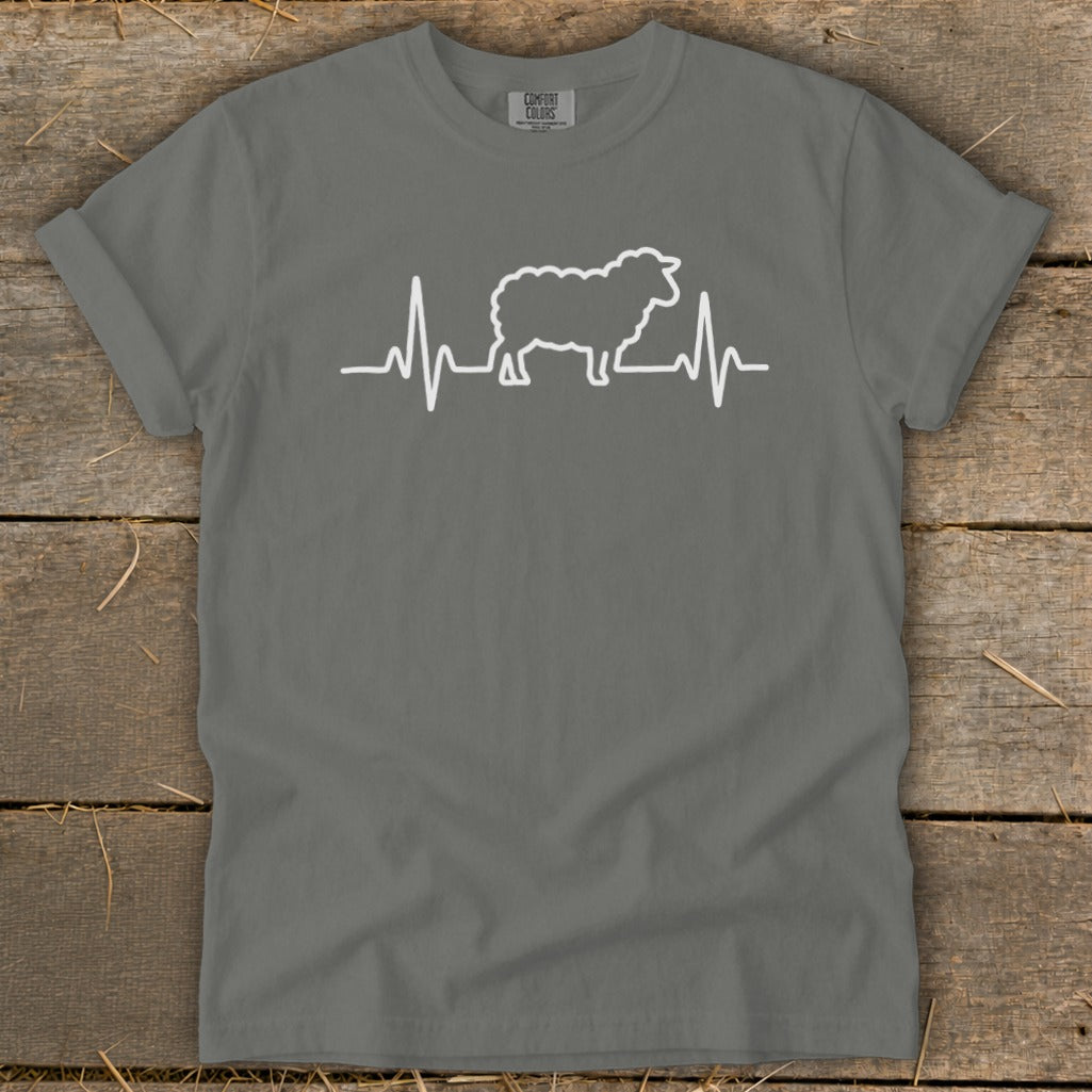 A charcoal grey t-shirt featuring a white graphic of a sheep silhouette inside a heartbeat monitor line.