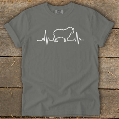 A charcoal grey t-shirt featuring a white graphic of a sheep silhouette inside a heartbeat monitor line.
