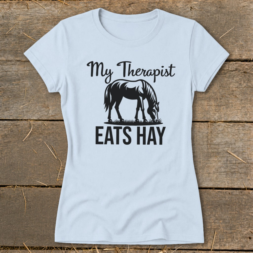 Light blue t-shirt with black text and horse graphic that reads "My Therapist EATS HAY".