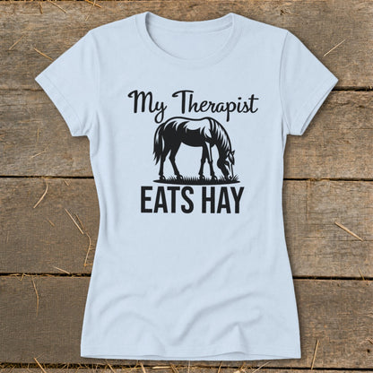 Light blue t-shirt with black text and horse graphic that reads "My Therapist EATS HAY".