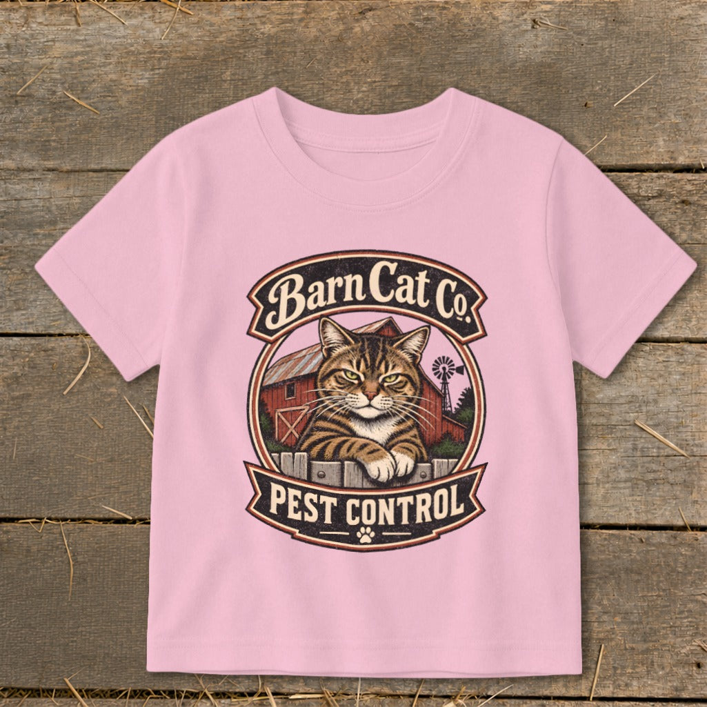 A pink t-shirt featuring a vintage Barn Cat Co Pest Control graphic with a tabby cat.