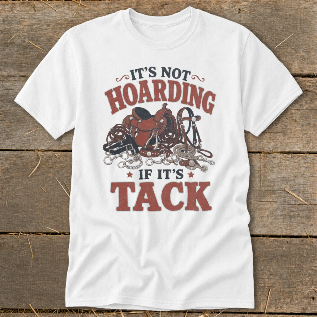 White t-shirt with "It's not hoarding if it's tack" and horse tack graphics.