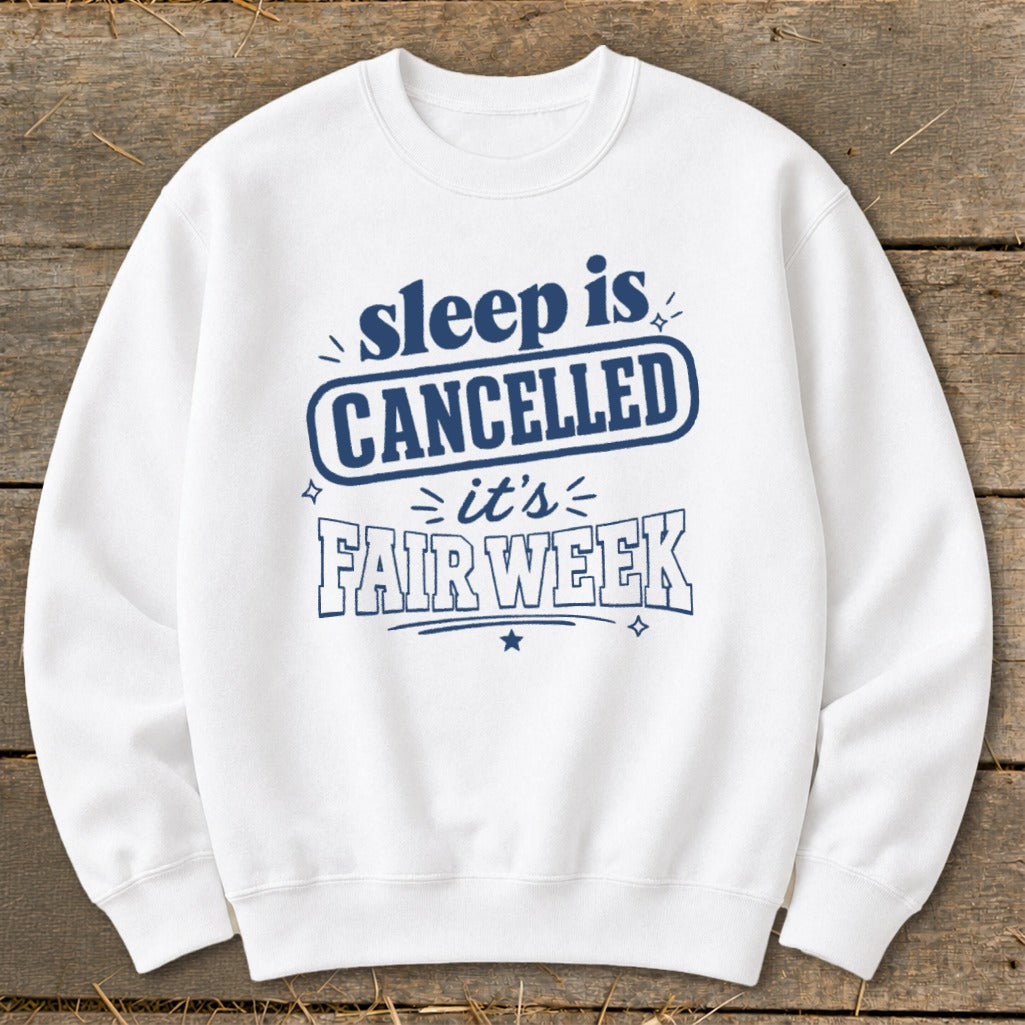 White sweatshirt with blue text reading "sleep is CANCELLED it's FAIR WEEK".