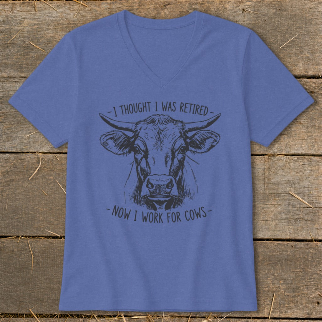V-neck t-shirt with a sketch of a cow and text "-I THOUGHT I WAS RETIRED- -NOW I WORK FOR COWS-".