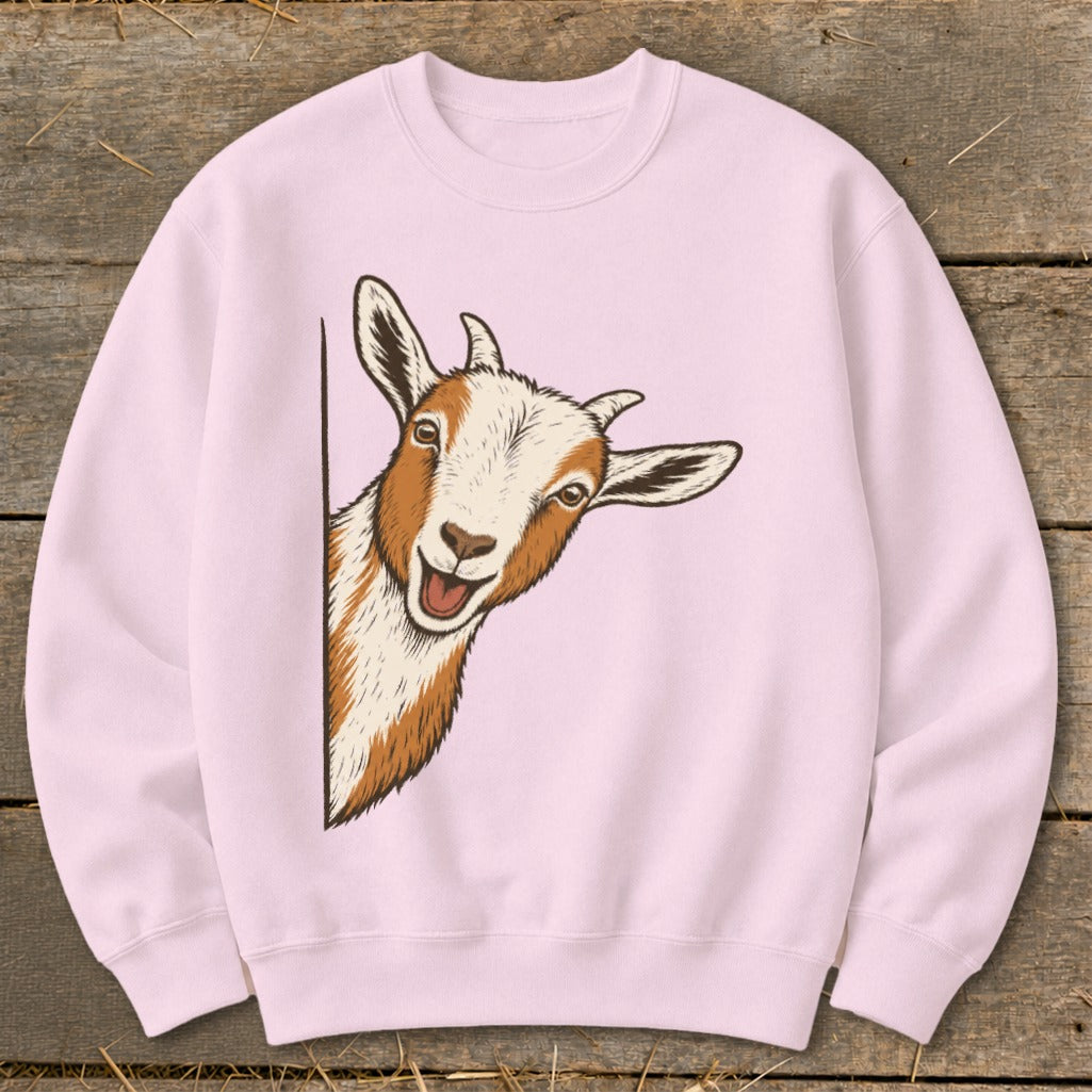 Pink sweatshirt with a cartoon drawing of a happy goat peeking from the left.