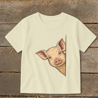 Cream t-shirt with a cartoon pig peeking from the side.