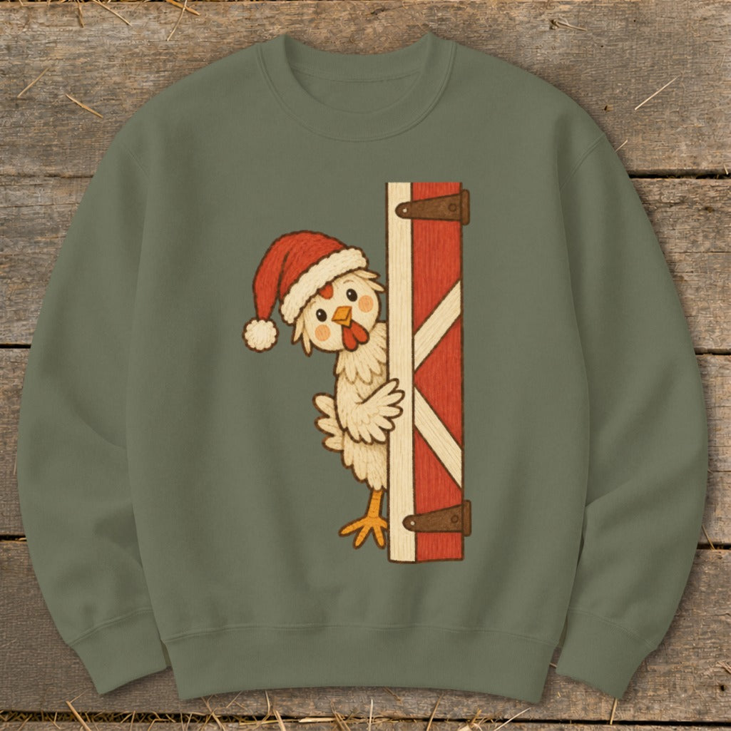 Chicken in Santa hat peeking from behind a red barn door.