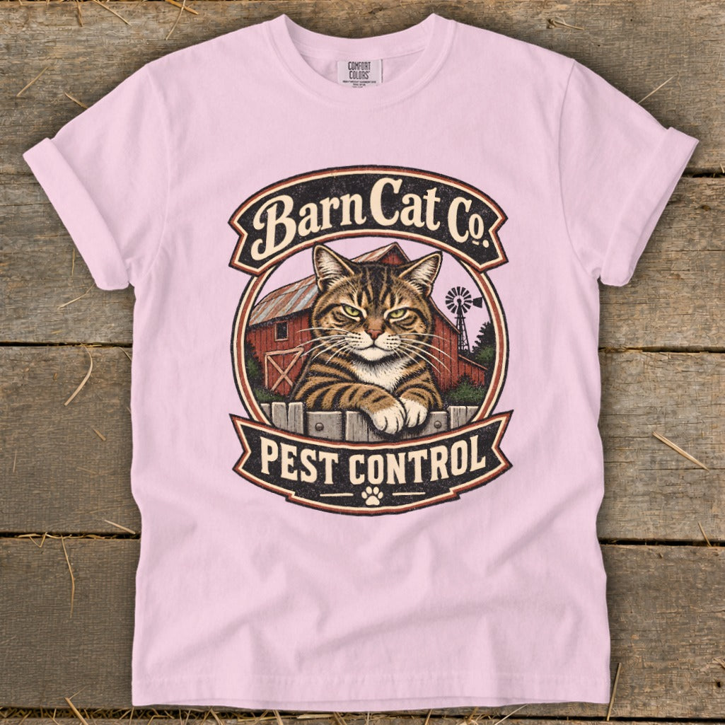 Light pink t-shirt featuring a vintage Barn Cat Co Pest Control graphic with a tabby cat.