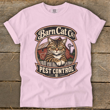 Light pink t-shirt featuring a vintage Barn Cat Co Pest Control graphic with a tabby cat.