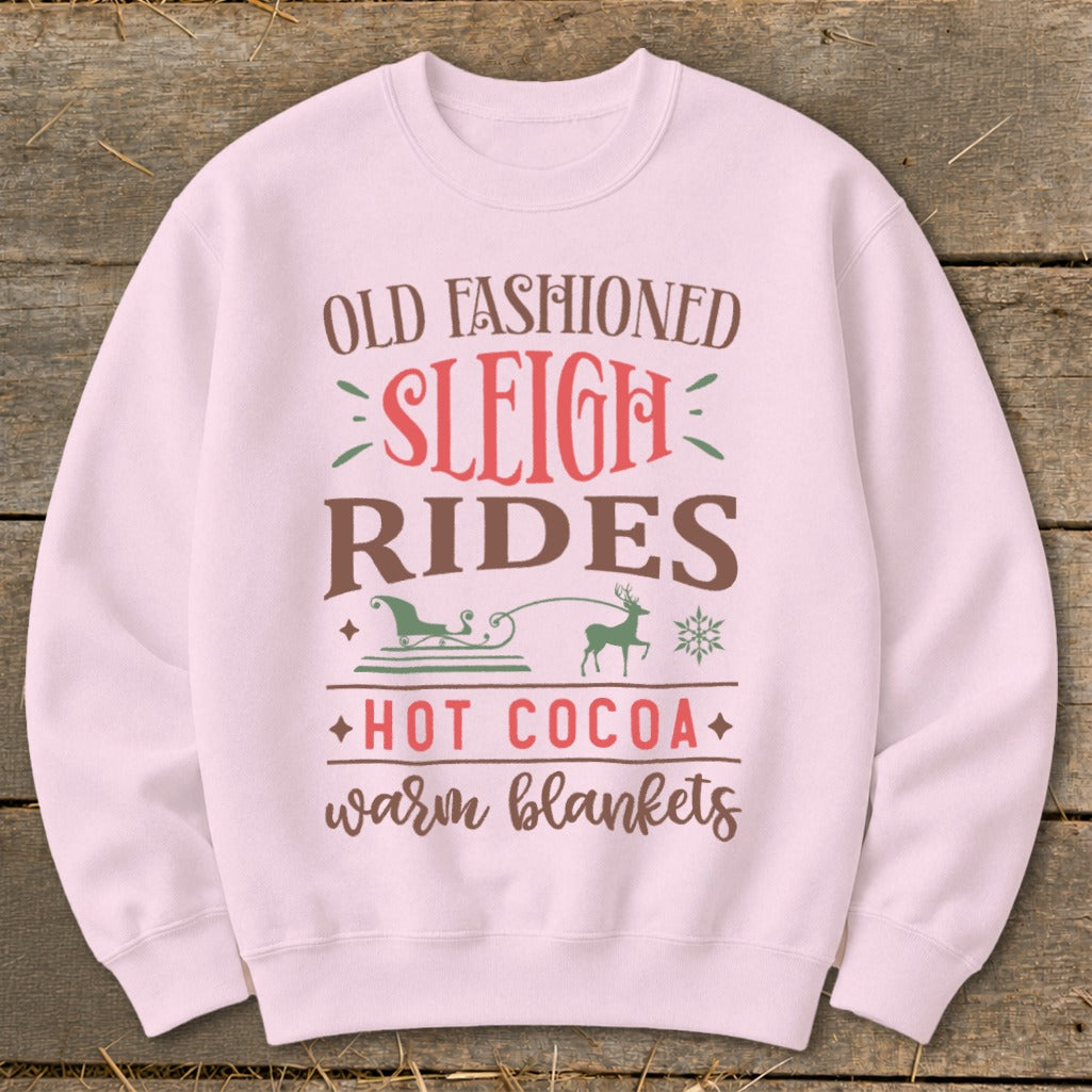 Pink sweatshirt with "Old Fashioned Sleigh Rides Hot Cocoa Warm Blankets" text and graphics.