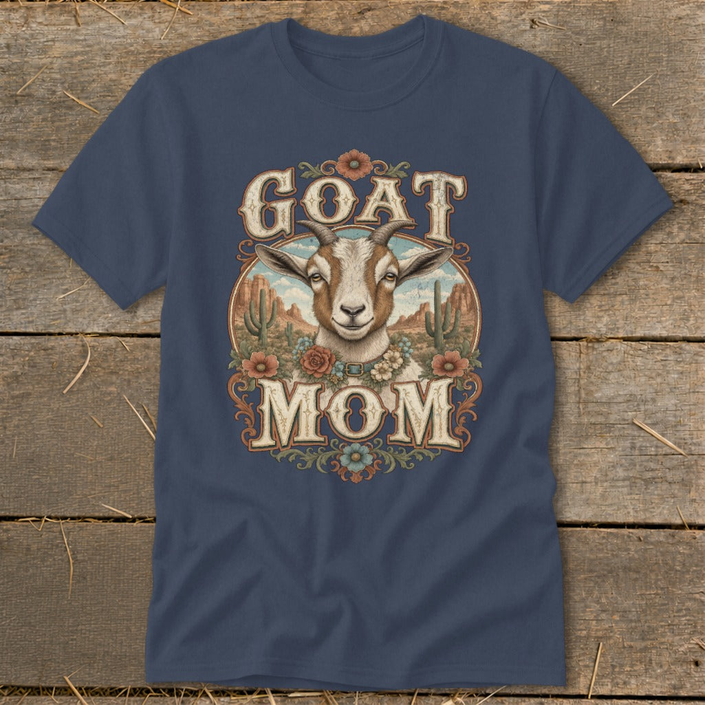 Goat Mom graphic on navy blue t-shirt with desert landscape background.