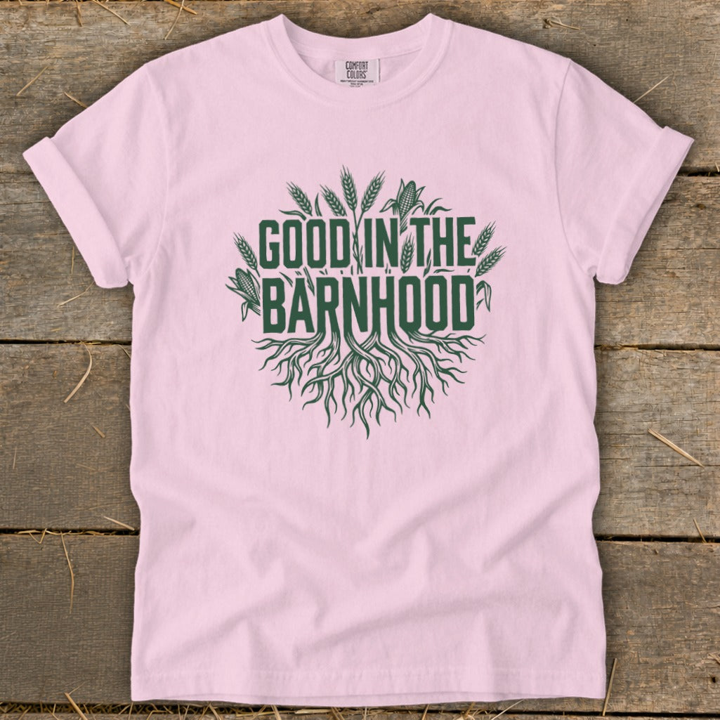 Pink t-shirt with green text and graphics reading "GOOD IN THE BARNHOOD".