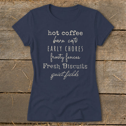 Navy t-shirt with text listing hot coffee, barn cats, chores, fences, biscuits, and fields.