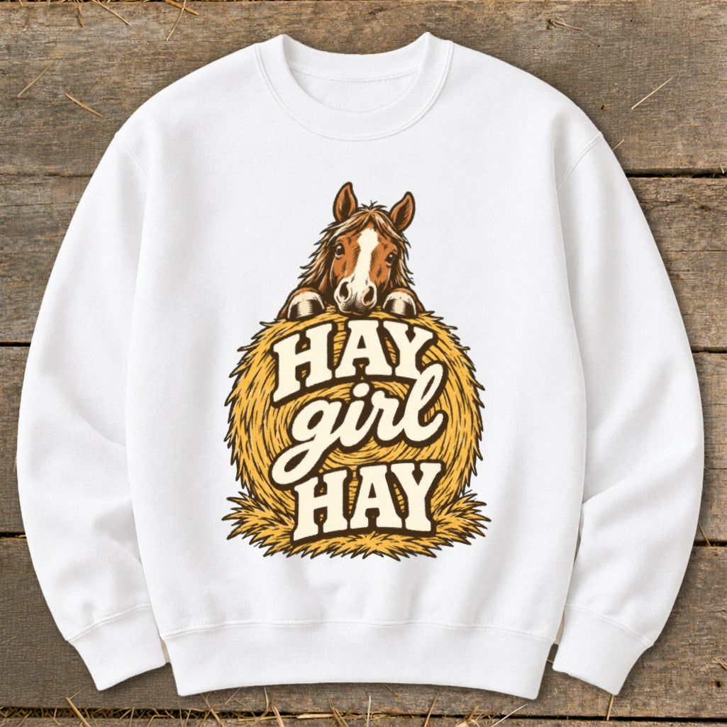 White sweatshirt with horse over hay bale graphic saying "Hay Girl Hay".