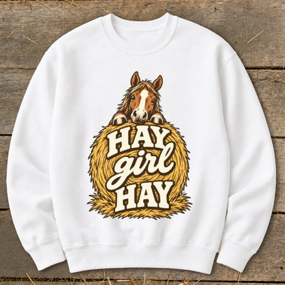 White sweatshirt with horse over hay bale graphic saying "Hay Girl Hay".