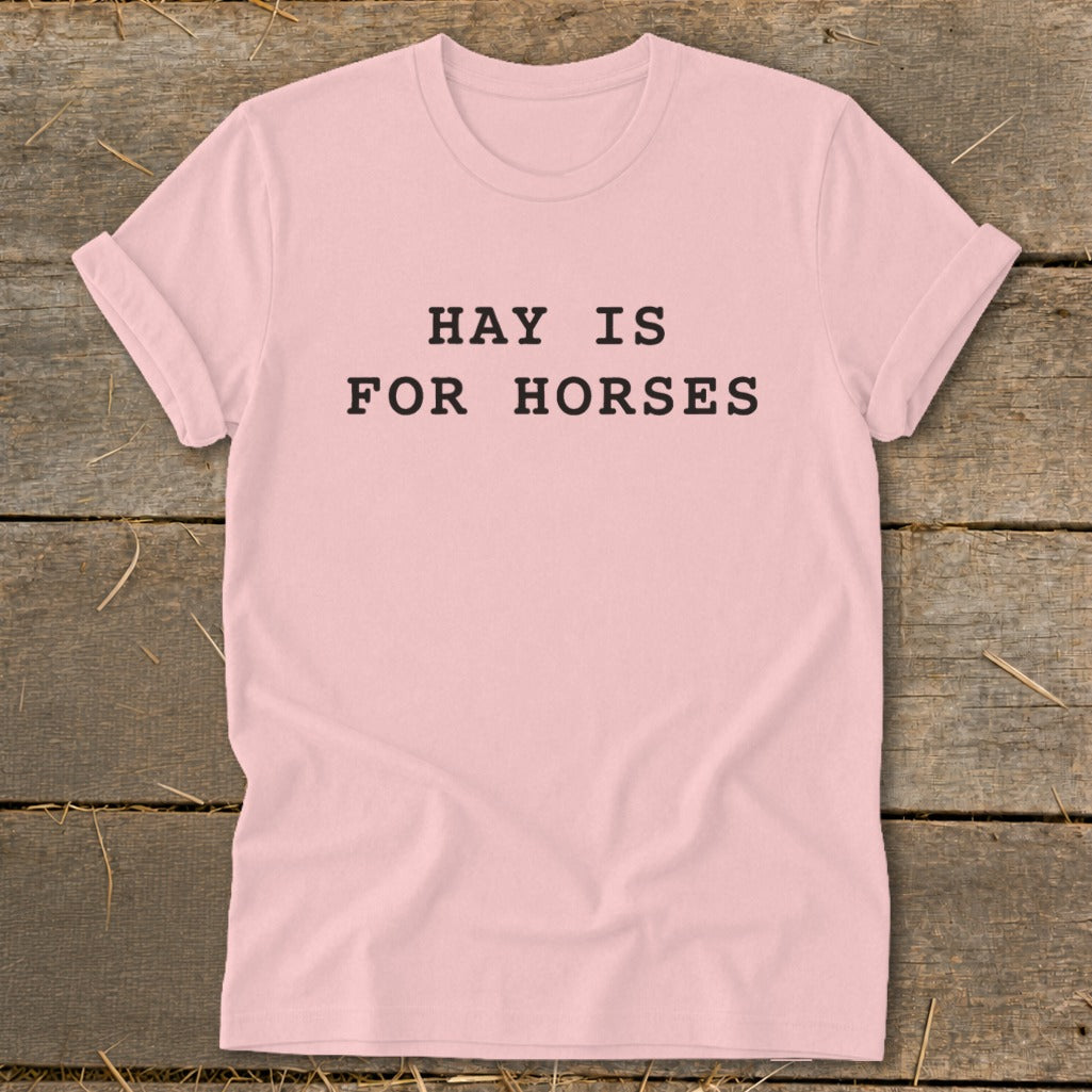 Pink t-shirt with black text reading "HAY IS FOR HORSES."
