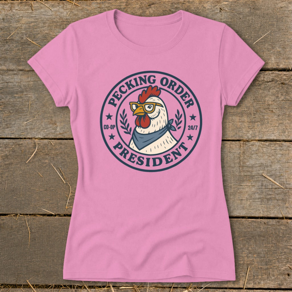 Pink t-shirt with a chicken wearing glasses and a bandana, with text "Pecking Order President".