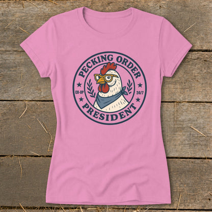 Pink t-shirt with a chicken wearing glasses and a bandana, with text "Pecking Order President".