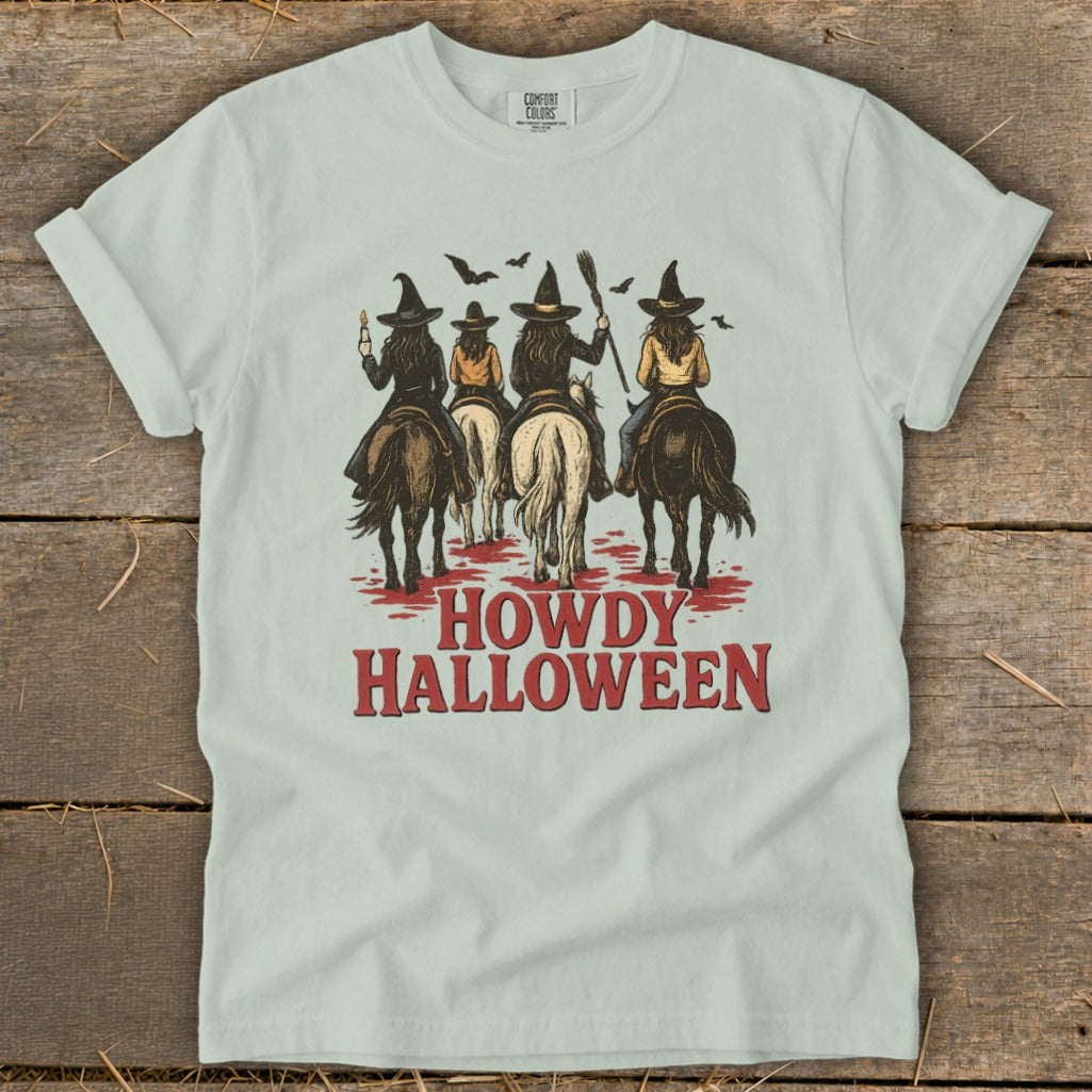 Witches on horseback with bats and "Howdy Halloween" text.