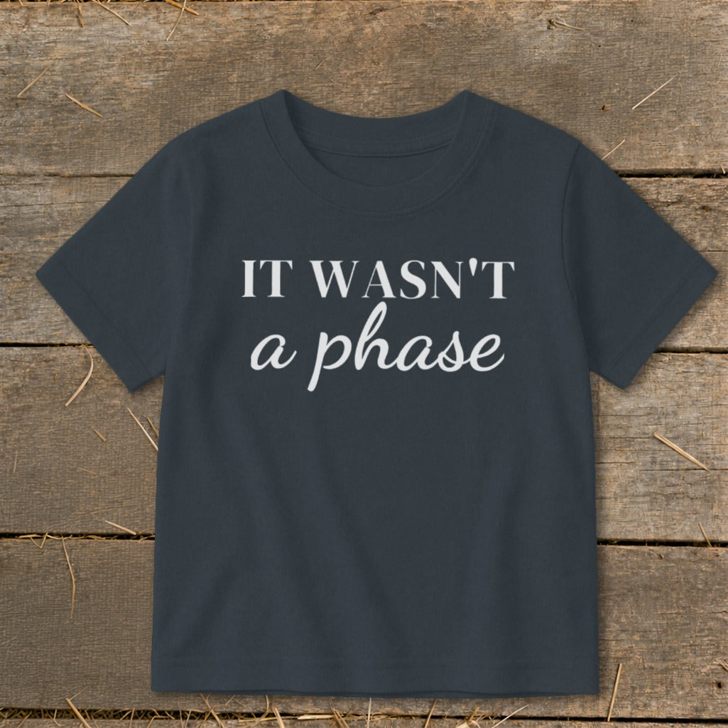 Dark grey t-shirt with white text "IT WASN'T a phase".