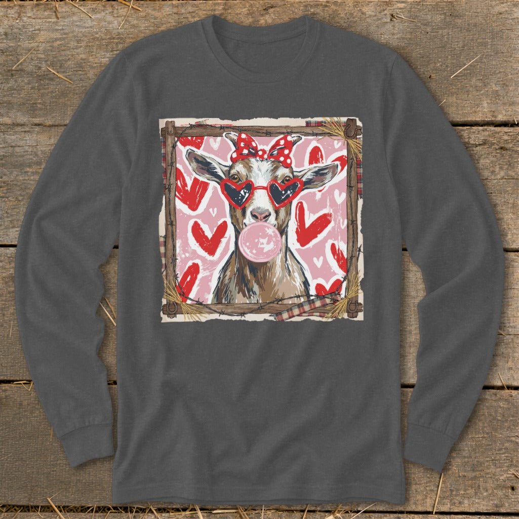 Goat wearing heart sunglasses and a bow blows bubblegum, with hearts in the background.
