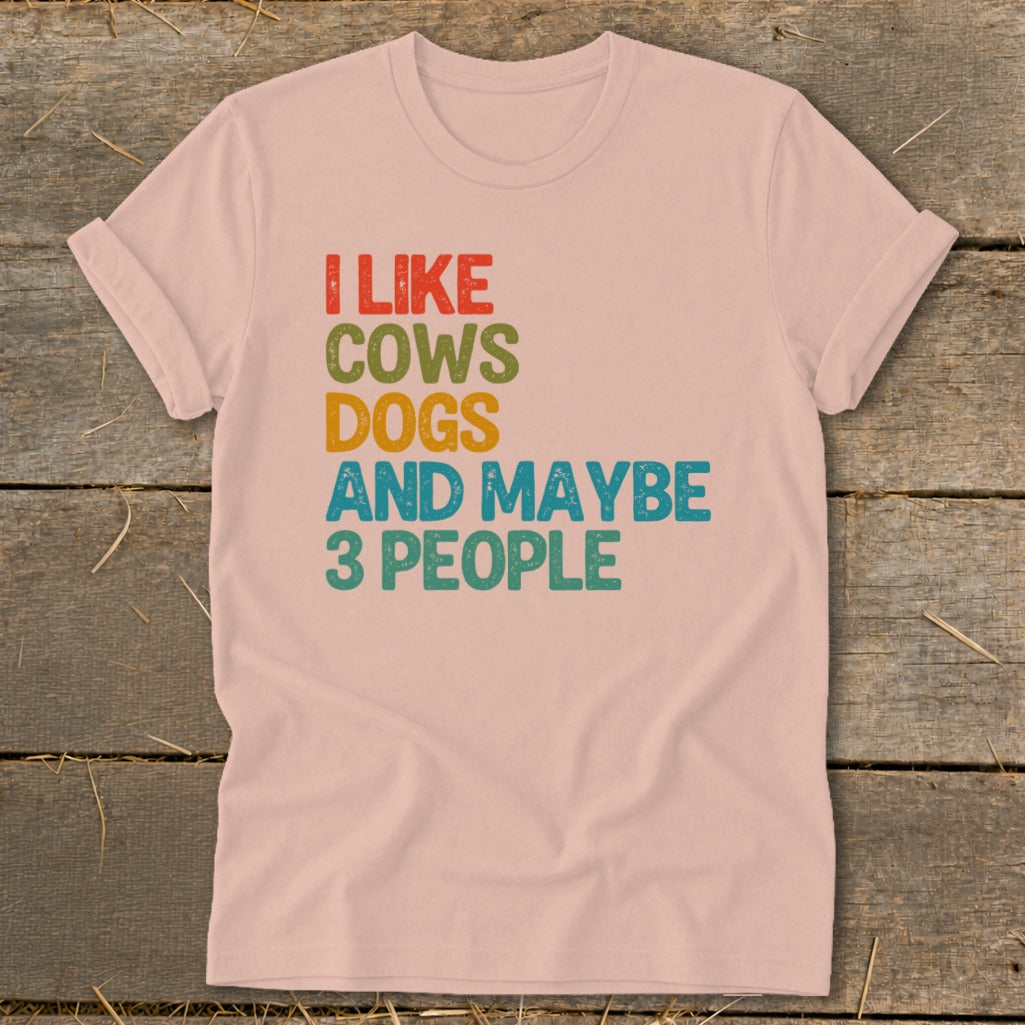 Pink t-shirt with text "I LIKE COWS DOGS AND MAYBE 3 PEOPLE".
