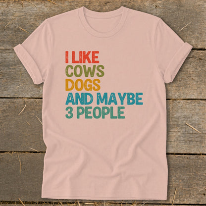 Pink t-shirt with text "I LIKE COWS DOGS AND MAYBE 3 PEOPLE".